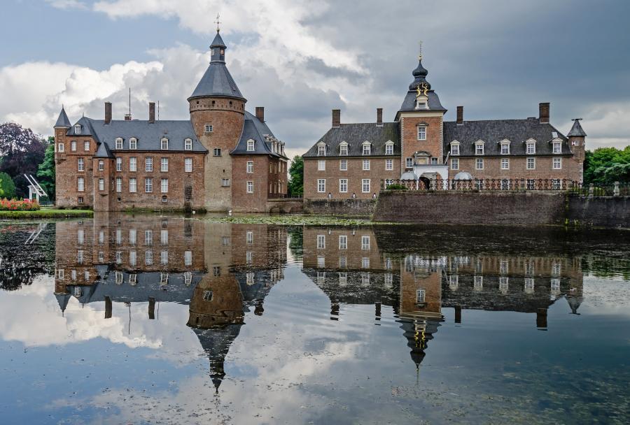 Water castle in Westphalia (Germany). An impressive building in the middle of a lake. 